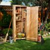 Summer Cedar A neatly organized cedar wooden garden shed with the door open, displaying various gardening tools and supplies, nestled in a lush backyard garden. summercedar.com