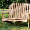 Summer Cedar A wooden Shae Love Seat situated on a lawn, offering a relaxing spot to enjoy the tranquility of a garden setting. summercedar.com