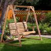 Summer Cedar A wooden swing bench nestled in a serene garden with lush green grass and a variety of plants, offering a tranquil spot to relax and enjoy nature. Discover more at Summer Cedar. summercedar.com