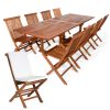 Summer Cedar A set of wooden outdoor furniture from Summer Cedar, featuring a large rectangular table and multiple folding chairs, one with a white cushion, isolated on a white background. summercedar.com