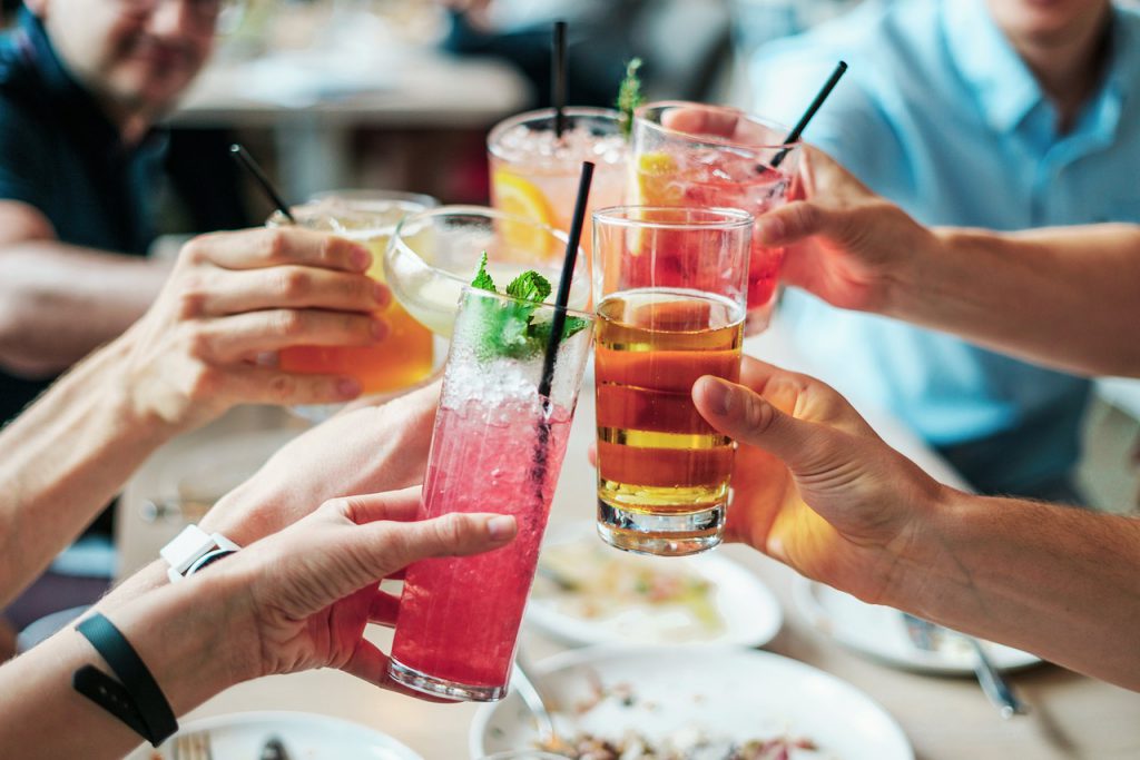Summer time cocktails with fruit and herbs served outdoors on a sunny day